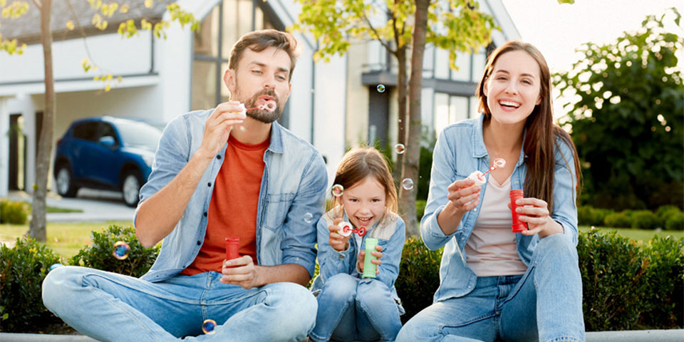 parents with young child in outdoor playground setting