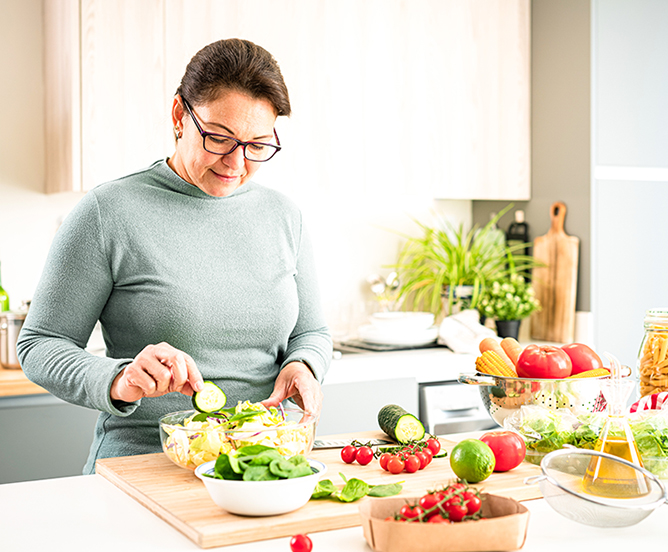 Woman prepping food in a bright kitchen