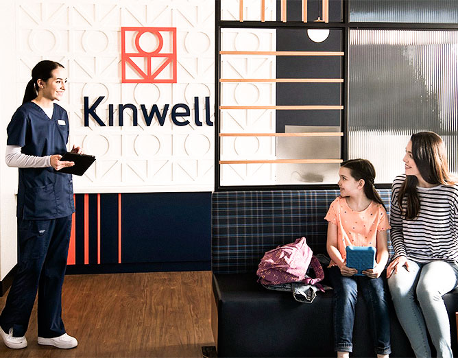 female adult with young child sitting in front of a medical practitioner at a Kinwell clinic