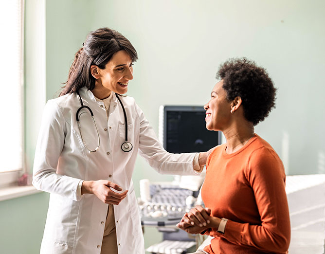 Healthcare provider meeting with patient in a clinic setting