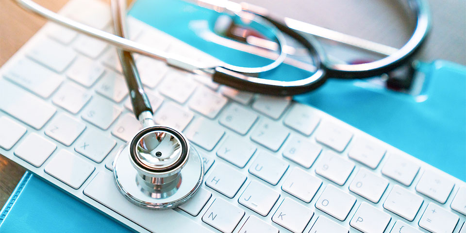 stethoscope laying across a keyboard