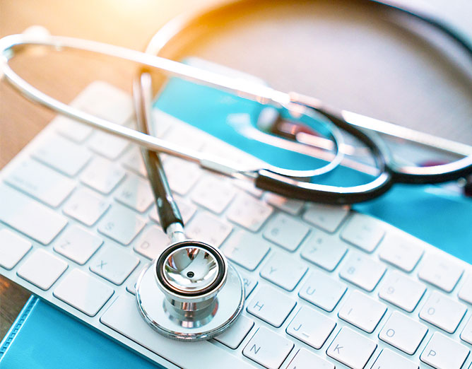 stethoscope laying across a keyboard