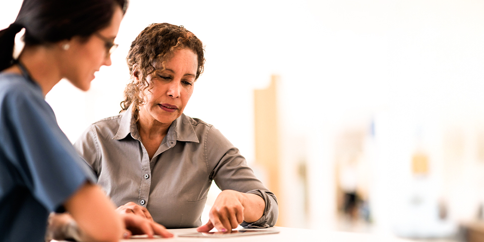 Adult female viewing a document with a healthcare provider